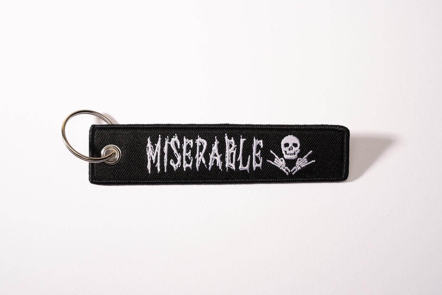 Miserable Stitched Tag Keychain